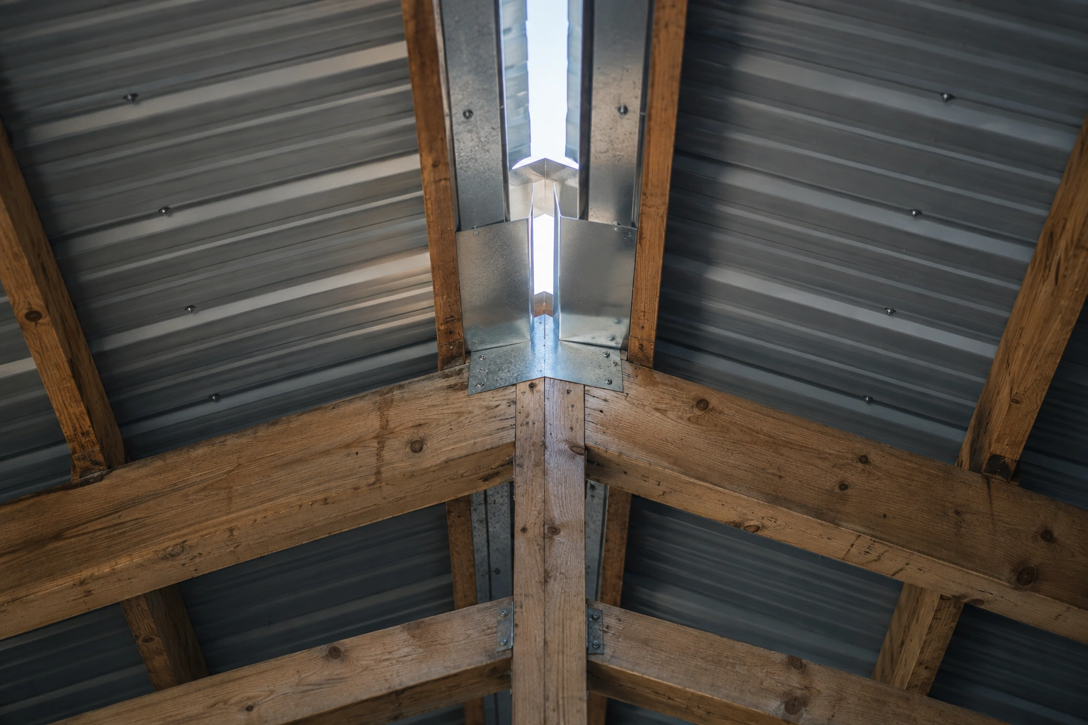 Gable end showing continuous vented soffit, a ridge vent running the roof length and a gable louvre